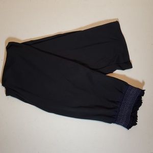 Black pants with purple design on the waist.